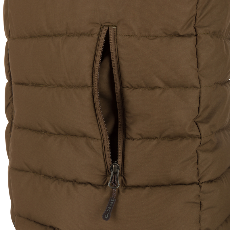 Close-up of the LST Double Down Layering Vest, highlighting the durable reverse-coil zipper and part of the microfleece-lined collar for added warmth and comfort.