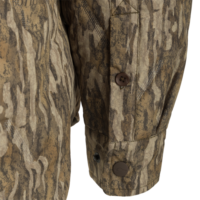 undefined: A close up of the LST Double Down Jac-Shirt, featuring a camouflage fabric and a brown button.