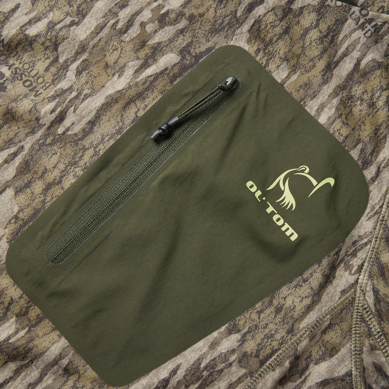 Pocket close-up on Early Bird Gator Hoodie with Insect Repellent features a green zipper on camouflage fabric,