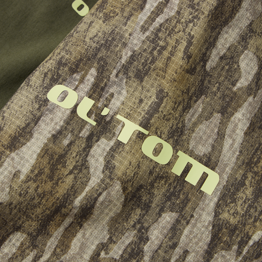 Half Zip Pullover featuring Spider Web Technology with a close-up of its camouflage fabric, highlighting the durable, breathable material ideal for turkey hunting.