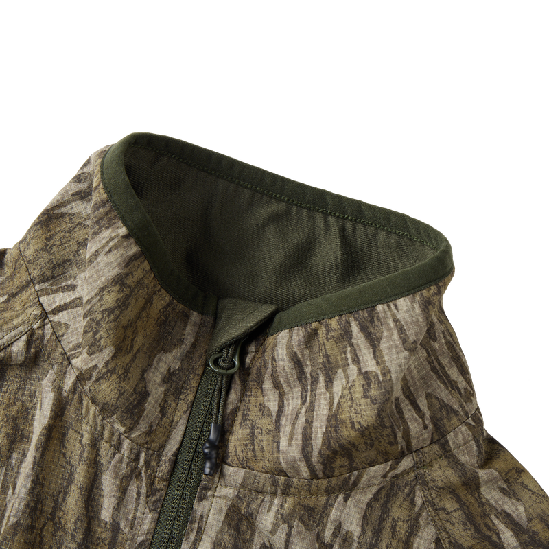 Half Zip Pullover with Spider Web Technology featuring a close-up of the jacket's zipper and breathable fabric, ideal for turkey hunting.