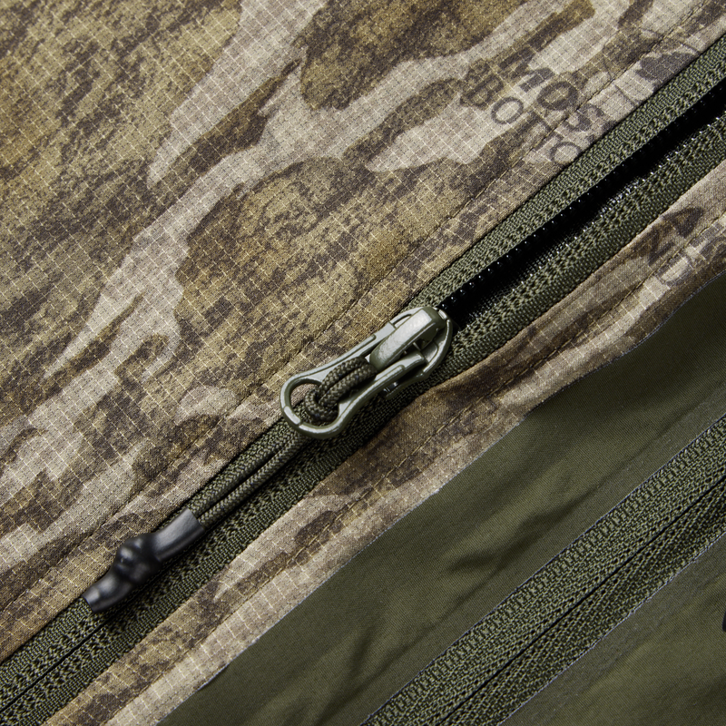 Half Zip Pullover with Spider Web Technology, showcasing a close-up of the durable YKK zipper on a camouflage fabric surface.