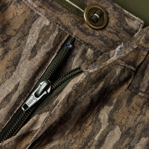 Early Bird Turkey Pant with Insect Repellent features a close-up of a durable YKK zipper and metal button, emphasizing its functional design for hunting.