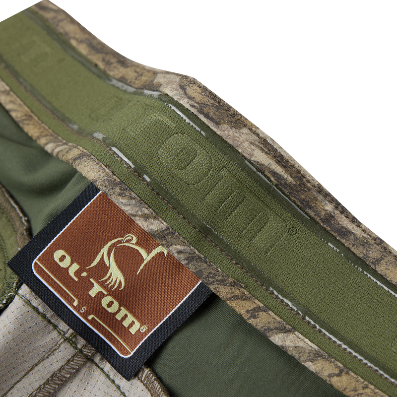 Close-up of the Turkey Pant with Spider Web Technology, highlighting the fabric's texture and label, emphasizing its stretch, breathability, and durability for silent hunting.