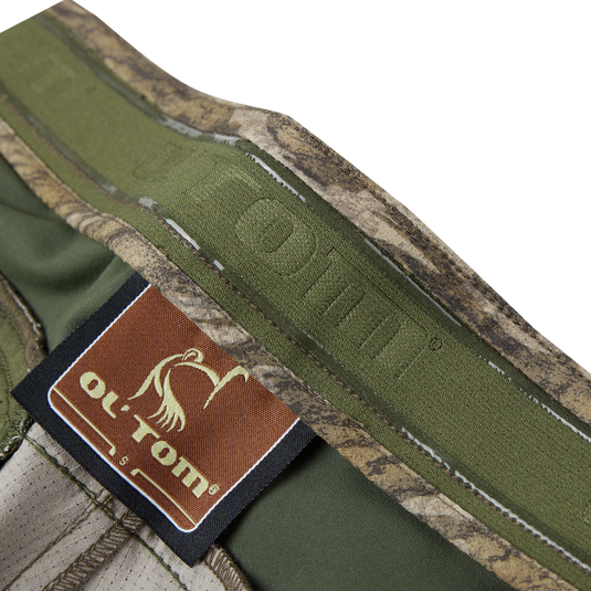 Close-up of the Turkey Pant with Spider Web Technology, highlighting the fabric's texture and label, emphasizing its stretch, breathability, and durability for silent hunting.