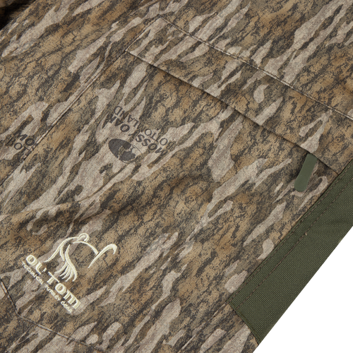 Close-up of a camouflage jacket pocket featuring the Turkey Pant with Spider Web Technology, highlighting its stretch fabric and reinforced, water-resistant design for hunting.