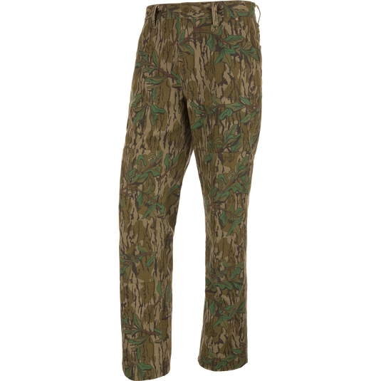 Throwback 80 Field Pant featuring camouflage design, durable cotton twill, reinforced knees, and antique brass riveted pockets, ideal for hunting and outdoor activities.