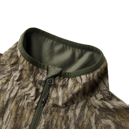 Eqwader Half Zip Pullover featuring a close-up of the water-resistant YKK zipper and ergonomic thumbholes, showcasing breathable and durable spider web technology for hunting apparel.