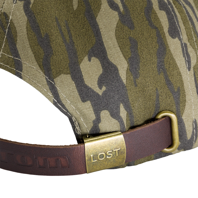 Close-up of the Ol' Tom X Lost Hat Goat Rope Cap featuring a brass buckle and embossed leather strap, ideal for outdoor adventures.