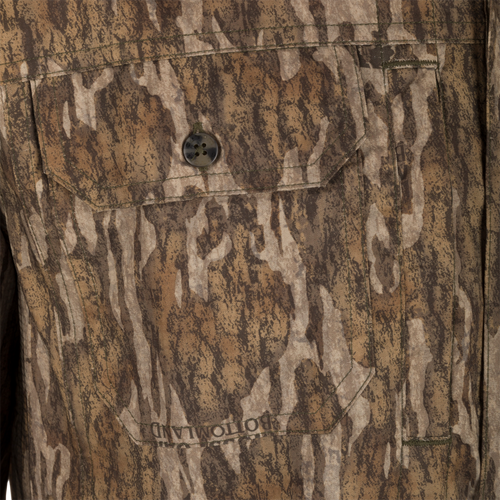 Men's Camo Wingshooter Trey Shirt L/S, close-up of front, highlighting button-through flap chest pockets, hidden button-down collar, and vented cape back for hunting and outdoor activities.