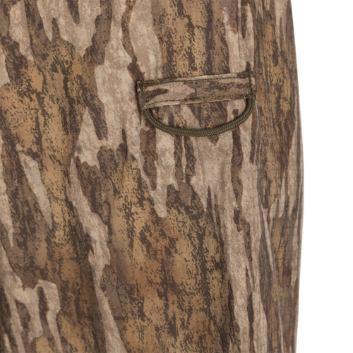 Men's Camo Wingshooter Trey Shirt L/S close-up showing fabric texture, button-through flap chest pocket, and hidden zippered pocket for hunting gear.