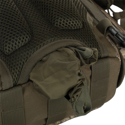 Run-N-Gun Turkey Chest Pack with multiple compartments, visible zipper, and mesh details, designed for hunting efficiency with detachable binocular harness and weather protection features.