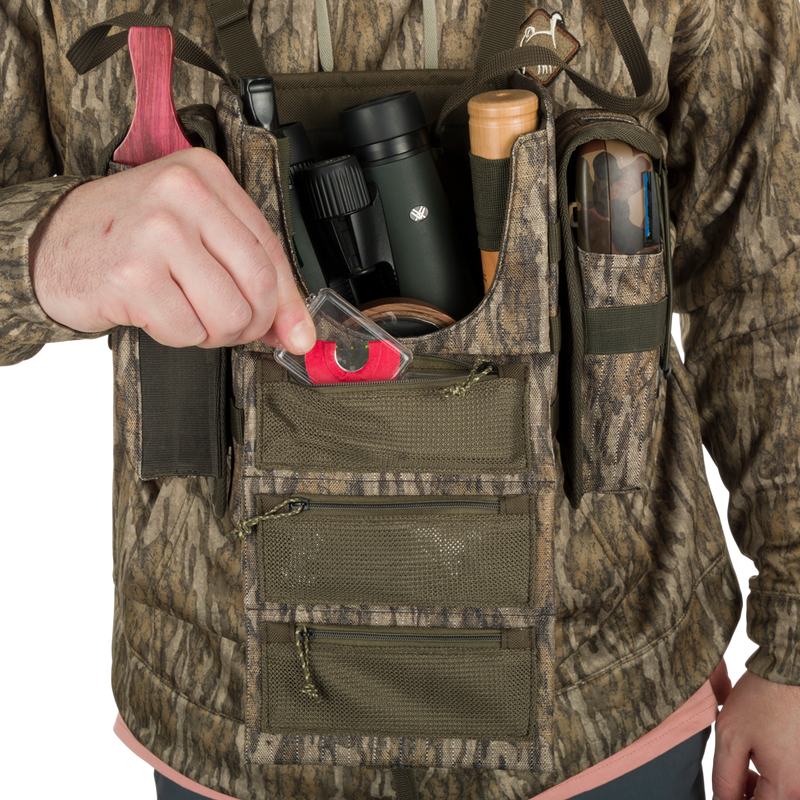 Run-N-Gun Turkey Chest Pack with camouflage vest, showcasing multiple pockets and detachable bino harness, ideal for hunting trips.