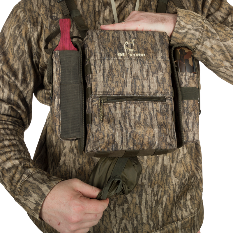 Run-N-Gun Turkey Chest Pack held by a person, featuring multiple pockets and a detachable bino harness, ideal for hunting trips with lightweight durability.