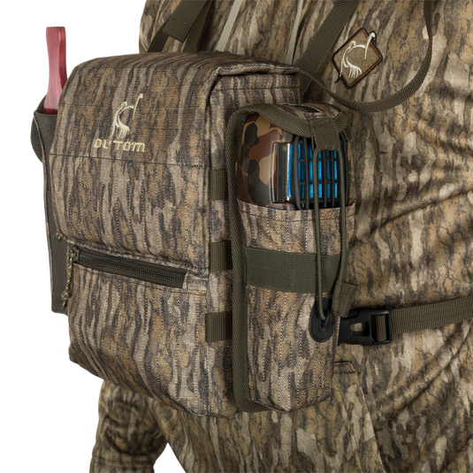 Run-N-Gun Turkey Chest Pack with camouflage design, featuring a removable bino harness, multiple pockets, and a stowable rain fly, ideal for hunting trips.