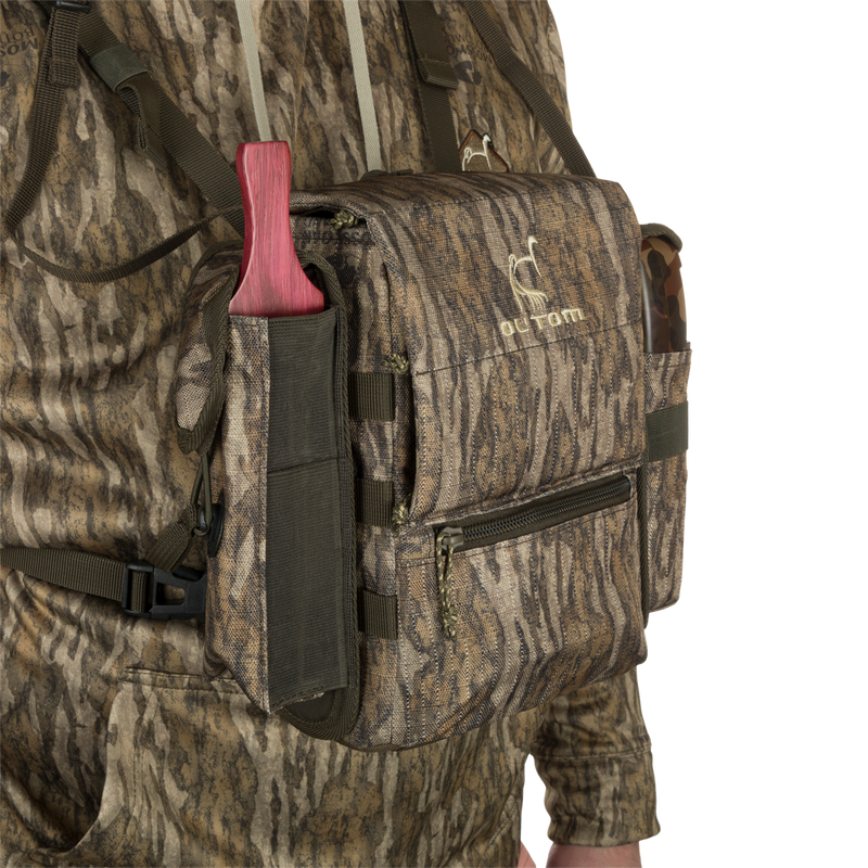 Run-N-Gun Turkey Chest Pack in camouflage, featuring multiple pockets, detachable bino harness, and a stowable rain fly, ideal for hunting trips.