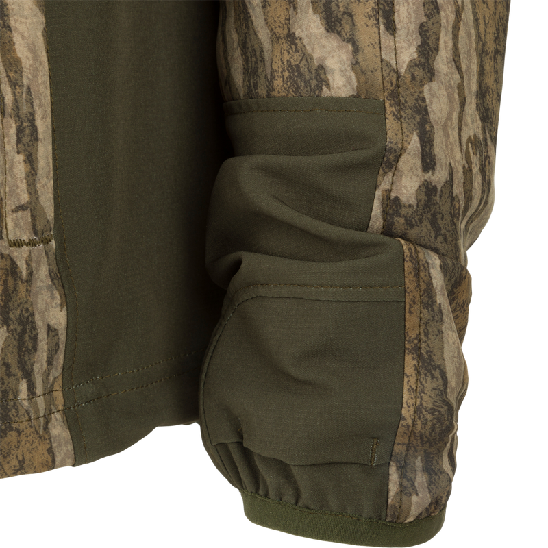 Close-up of the Rain Brake Lightweight Jacket, showcasing its camo pattern, adjustable hood, and multiple zippered pockets designed for outdoor enthusiasts.