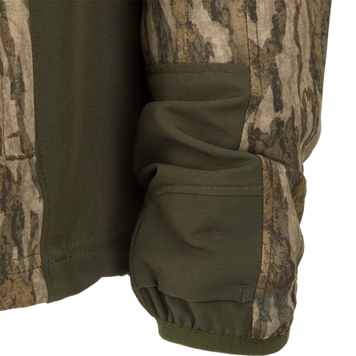 Close-up of the Rain Brake Lightweight Jacket, showcasing its camo pattern, adjustable hood, and multiple zippered pockets designed for outdoor enthusiasts.