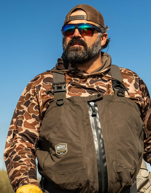 A man wears the Three End Hoodie with sunglasses and a camouflage jacket, featuring a kangaroo pocket and lined hood with drawstrings.