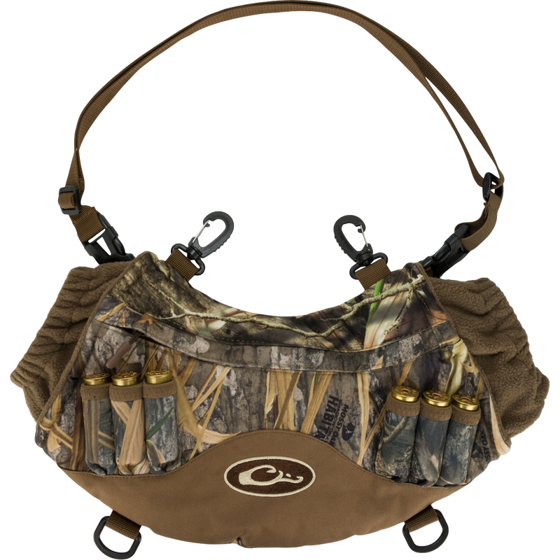 Alt text: LST Handwarmer Muff with camouflage pattern, featuring carabiner clips, shell loops, and a waterproof storage pocket for phone access.