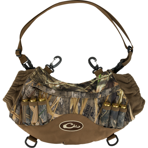 Alt text: LST Handwarmer Muff with camouflage pattern, featuring carabiner clips, shell loops, and a waterproof storage pocket for phone access.