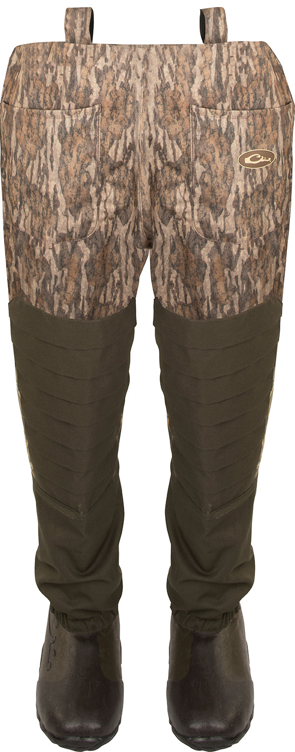 Guardian Elite™ 6-Layer 4-in-1 Waist-High Wader with Tear-Away Liner, featuring camouflage pants, rugged boots, and advanced insulation for versatile hunting and fishing conditions.