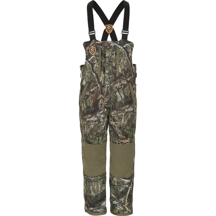 Youth Silencer Bib With Agion Active XL, a camouflage overalls with straps and vertical pockets for hunting gear.