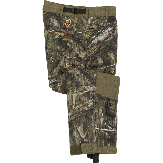 Youth Silencer Pant with Agion Active XL, featuring a camouflage pattern, front slash pockets, rear zippered pocket, and durable polyester outer with Sherpa fleece interior.