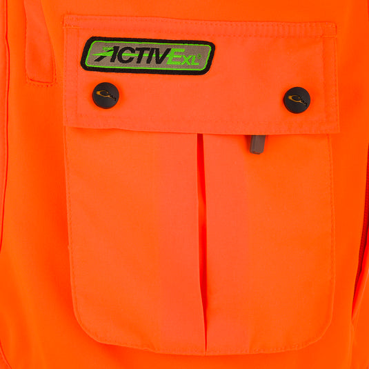 Close-up of the Blaze Orange Vest with Scent Control's vertical chest pocket and logo patch, showcasing detailed craftsmanship and functional storage.