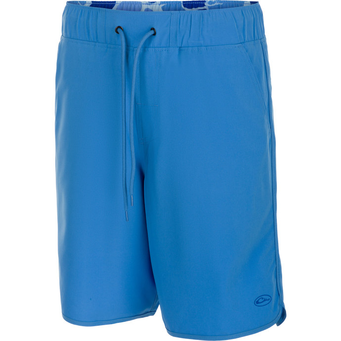 A versatile Commando Lined Volley Short 9 inch with built-in liner. Features quick-drying fabric, 4-way stretch, and adjustable waistband. Includes front and back pockets with hidden zippers. Perfect for beach to bar.