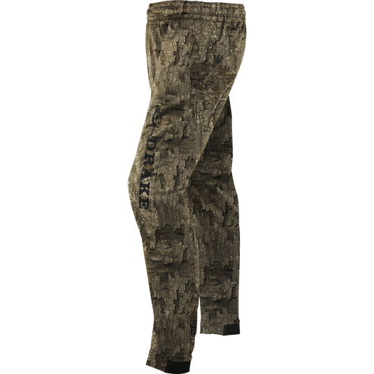 Fleece Wader Pant made of 100% Polyester Fleece with front handwarmer pockets, elastic waist, and snug fit tapered ankles, displayed in a camouflage pattern.