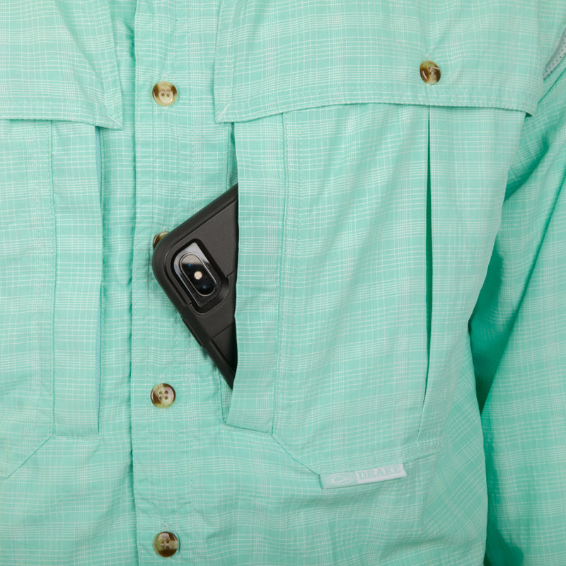 Wingshooter's Plaid Sun Shirt L/S with a cell phone in the chest pocket, showcasing the shirt's practical storage feature.