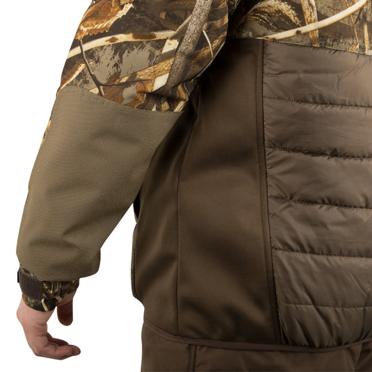 A person wearing the LST Guardian Flex Double Down Eqwader Full Zip Jacket w/ Hood, highlighting the camouflage pattern and detailed functional design.