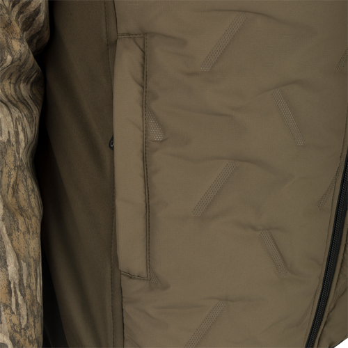 LST Guardian Flex Double Down Eqwader Full Zip w/ Hood: A close-up of a khaki jacket with a brown fabric surface and zipper.