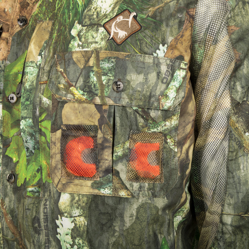 Close-up of the Vestless Mesh Back Shirt with Spine Pad, showing detailed pockets for calls and mesh panels for breathability, designed for hunting without a vest.